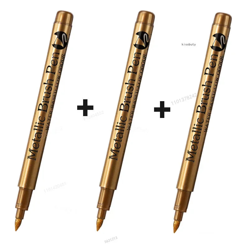 Three metallic brush pen markers in gold and black packaging shown at an angle