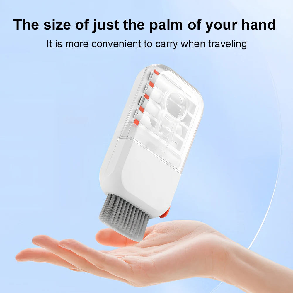 A hand is holding a white electronic cleaning kit with a brush head, demonstrating its convenient size for travel.