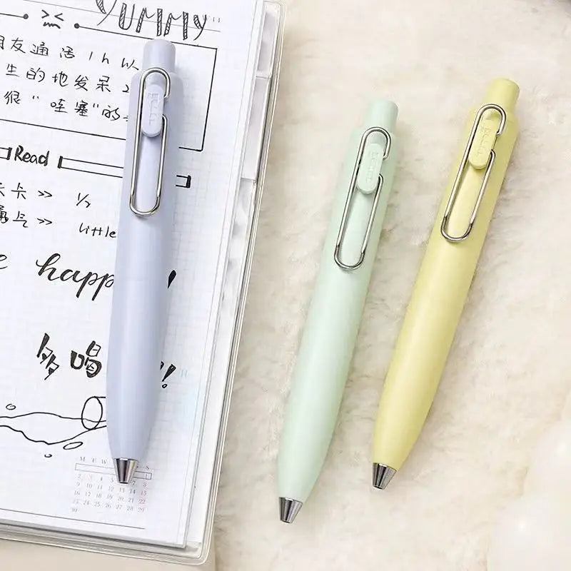 A light green Uni-Ball One Mini Cute Gel Pen is shown next to a spiral notebook.