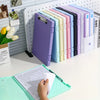 A row of colorful A4 document and photo storage file boxes in various shades of purple, green, pink, and blue.