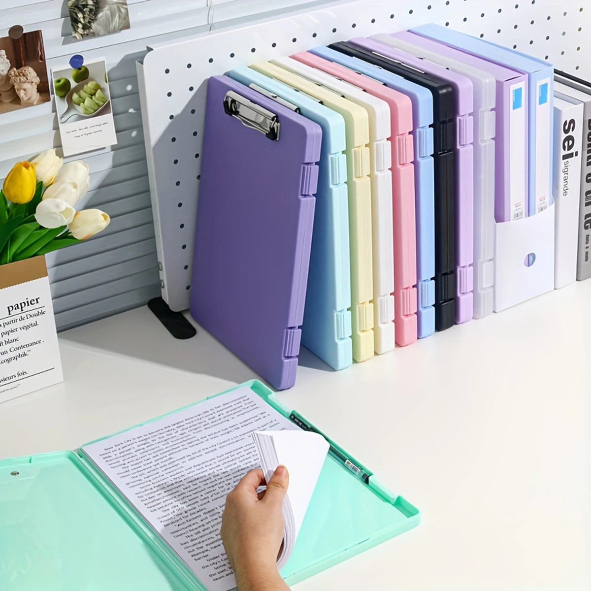 A row of colorful A4 document and photo storage file boxes in various shades of purple, green, pink, and blue.