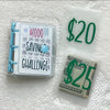 A set of budget binders and envelopes for a savings challenge including a $1000 savings challenge binder, a $20 envelope, and