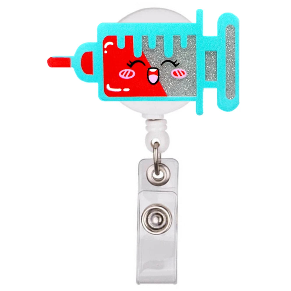 A colorful cartoon medical syringe shaped badge reel holder with a pink and blue design.