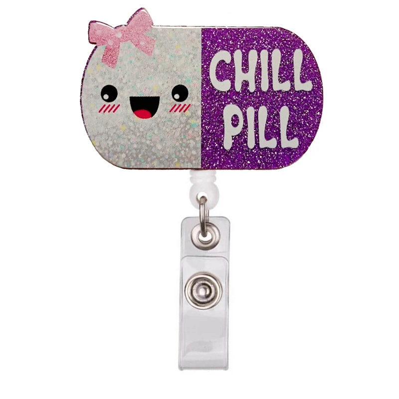 A colorful badge reel holder featuring a purple and white design with the text CHILL PILL and a pink bow.