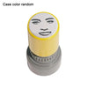 A yellow rubber stamp with a black face meme design on the top, shown from above.