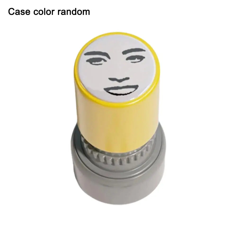 A yellow rubber stamp with a black face meme design on the top, shown from above.