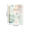 A spiral bound planner featuring watercolor floral designs and monthly tabs for planning.