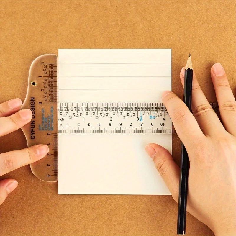 Hands hold a pencil and an acrylic T-square ruler set on brown paper for measuring or crafting.