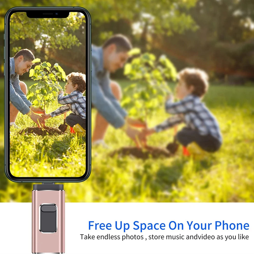 A pink universal USB flash drive is shown next to a smartphone displaying an outdoor scene of children planting a tree.