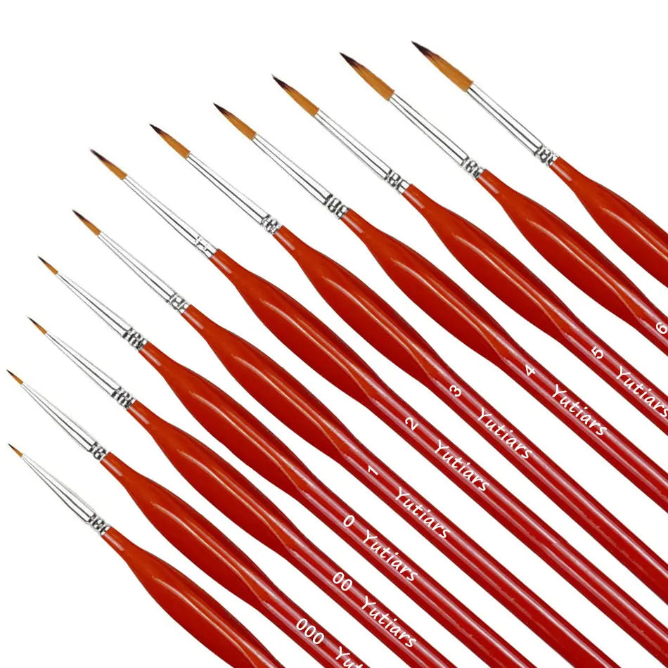 A set of professional miniature paint brushes with ergonomic handles, featuring red shafts and fine tips.