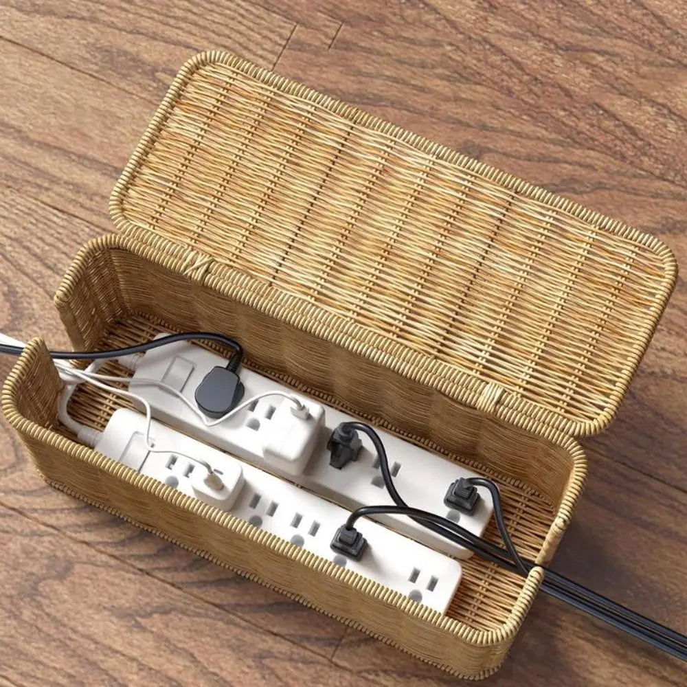 Handwoven rattan cable management box with lid containing white power strips and cables