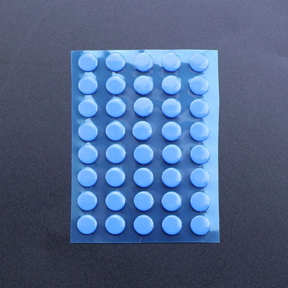 A rectangular sheet of blue adhesive glide feet for universal mouse skates, arranged in a grid.