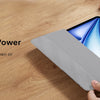 A hand holds a silver magnetic folio case for an iPad, demonstrating its instant reaction when opened or closed.