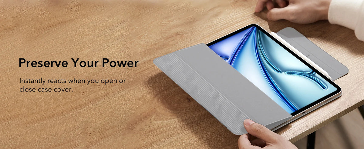 A hand holds a silver magnetic folio case for an iPad, demonstrating its instant reaction when opened or closed.
