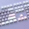 A collection of light purple and white PBT keycaps for MX Mechanical keyboards arranged in rows.