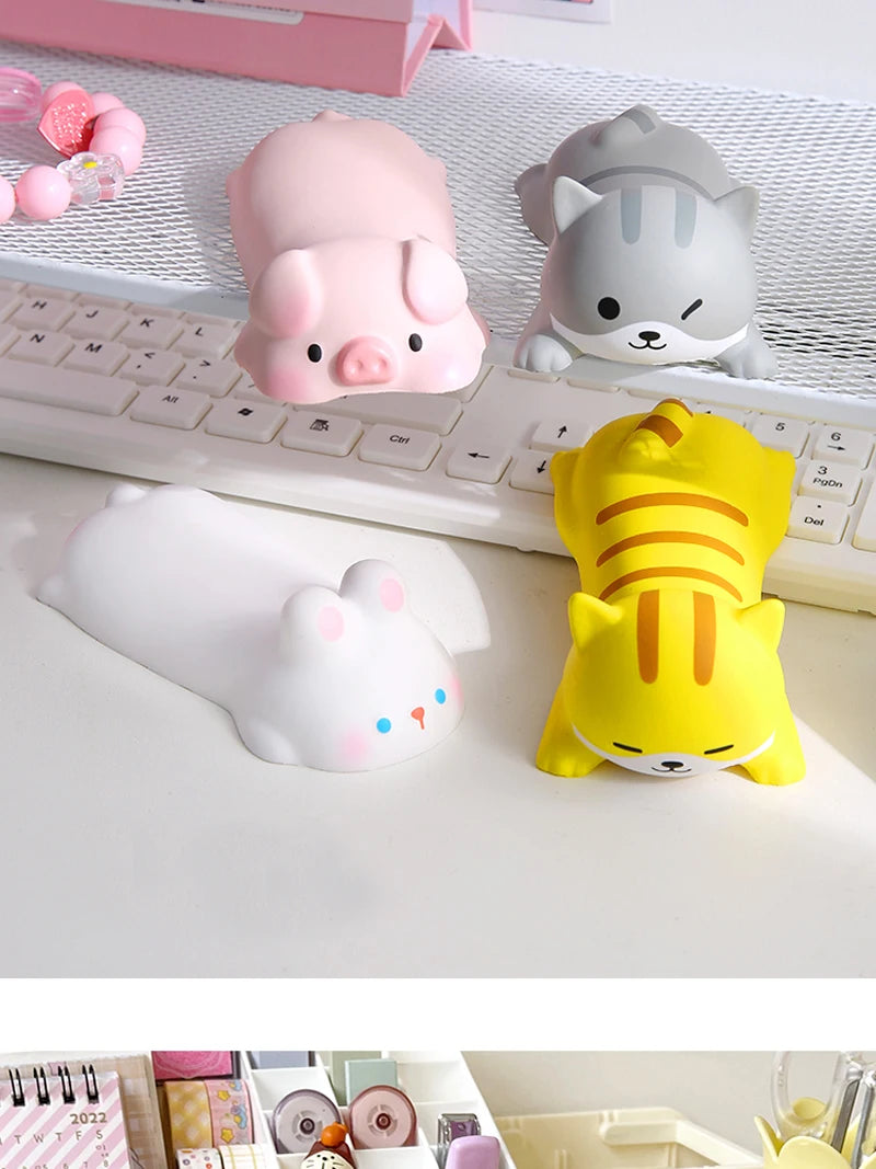 A collection of pink, gray, and yellow kawaii ergonomic wrist rests for mice and keyboards.