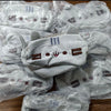 A pile of light gray plush cat pencil cases for stationery, packaged in clear plastic bags.