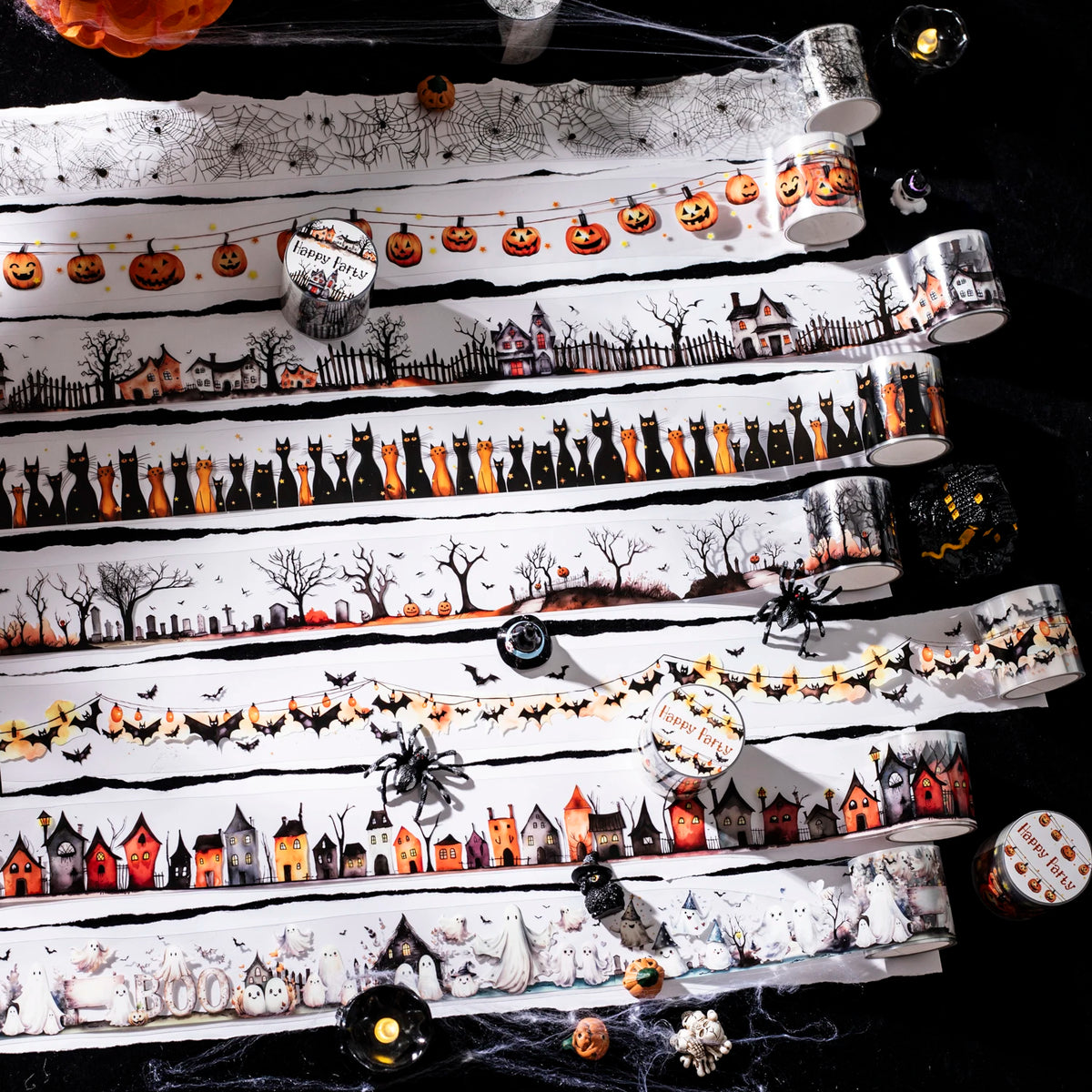 Rolls of vintage gothic Halloween masking tape featuring spooky designs and pumpkins for crafting
