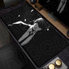 A black mouse pad featuring a white illustration of a person with long hair lying down on a dark background.