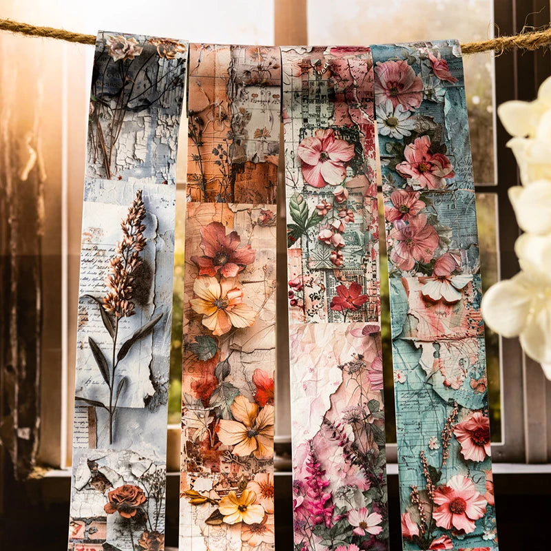 A collection of decorative washi tape featuring floral and botanical patterns tied together on twine.