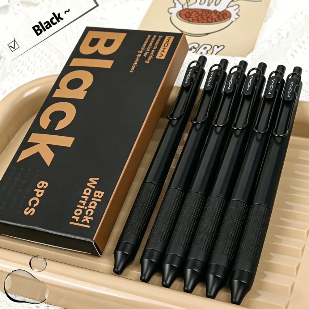 Une boîte de six stylos gel retractables noirs est présentée dans un plateau brun clair.