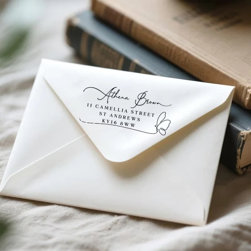 A white envelope with elegant script addressing Athena Brown at 11 Camellia Street, St Andrews, KY16 8WW