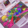 An anime-inspired gaming mouse pad featuring vibrant characters and artwork, displayed next to a tablet and a white mouse.