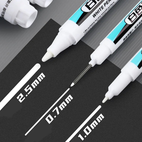 A close-up view of white permanent paint marker pens showing various tip sizes like 2.5mm, 0.7mm, and 1.0mm.