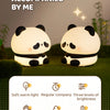 A pair of white panda silicone night lights are displayed against a green background, highlighting features like soft warm li