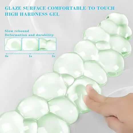 A close-up of a translucent green gel wrist rest showing its soft, bubble-like texture and durability.