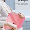 A hand holds a pink glittery protective stand cover for an iPad inside a light-colored bag.
