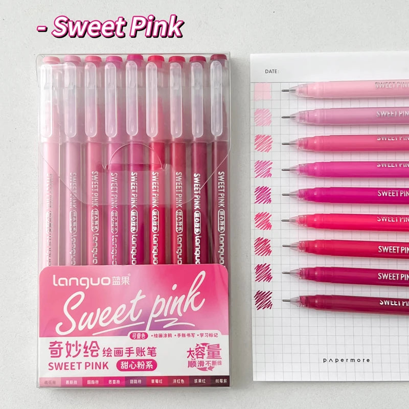 A set of nine pink gel pens in various shades and tips displayed next to a sheet of paper with matching colored pens.