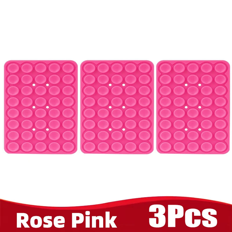 Three pink silicone suction cup phone holders in a grid pattern