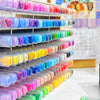 A display of numerous art acrylic paint markers organized in rows by color and type.