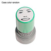 A round rubber stamp with a face design on the top, featuring a light green color.