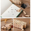 A collection of vintage wooden stamp seals and alphabet blocks used for card making and crafting.