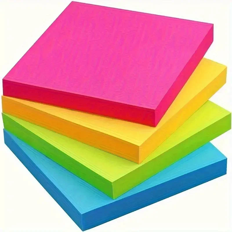 A stack of vibrant neon self-adhesive sticky notes in pink, yellow, green, and blue.