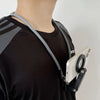 A person wearing a black shirt has a magnetic neck phone holder with a foldable tripod stand attached to their collar.
