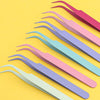 A set of pink and purple macaron precision tweezers laid diagonally on a yellow background.