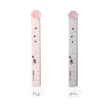 Pink and gray plastic ruler shaped like a cat paw for measuring