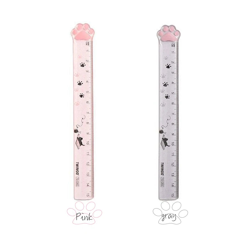 Pink and gray plastic ruler shaped like a cat paw for measuring