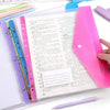 A close-up of an open A4 loose-leaf file with colorful paper and a purple pen resting on the desk.