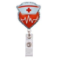 An intricate glitter acrylic ID badge clip shaped like a red heart with a white medical cross and an ECG line.