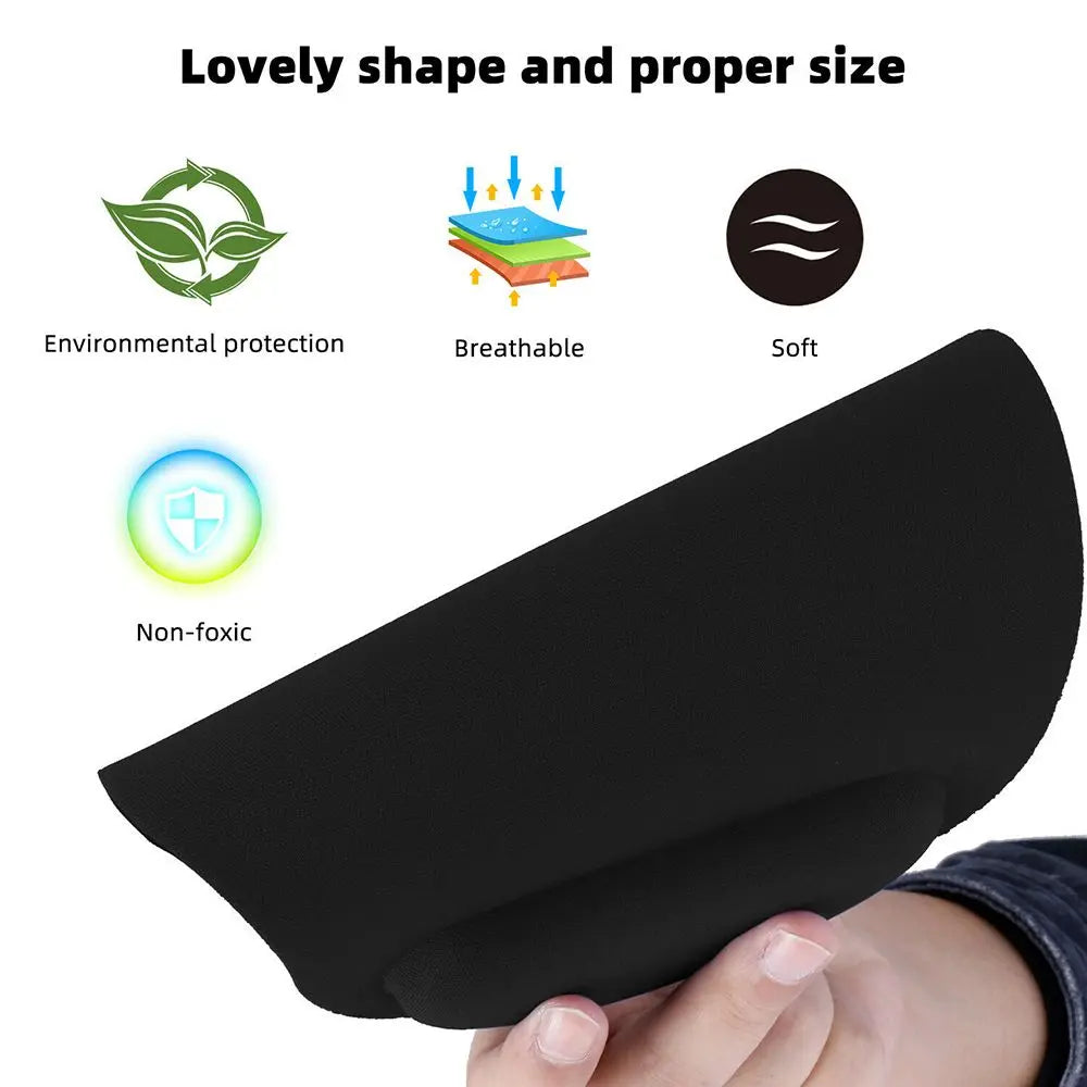 Black ergonomic mouse pad with a curved shape and wrist support shown being held by a hand.