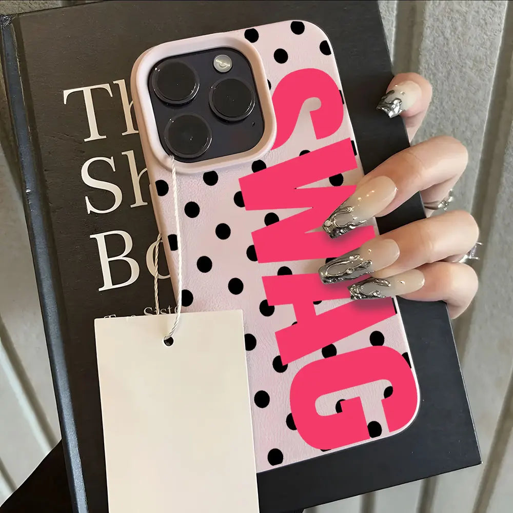 A pink polka dot phone case with the word SWAG printed in bright pink text, held against a dark background.