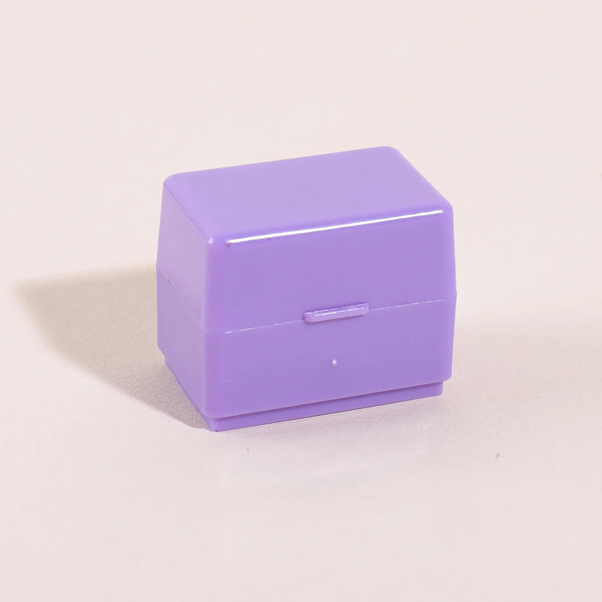A small, rectangular purple roller stamp used for privacy protection on confidential documents.