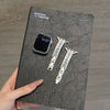 A black leather card features a smartwatch and two crystal-embellished watch straps.
