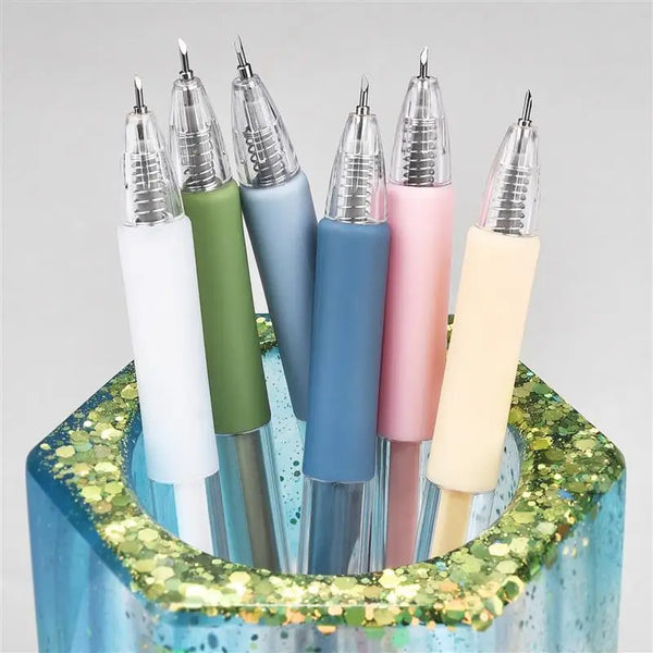 A set of six precision utility knives in various pastel colors, including mint green, blue, pink, and cream, displayed in a g
