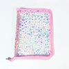 A pink transparent zipper photo binder filled with iridescent star-shaped confetti.