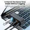 A black USB hub with four ports is shown connected to a laptop keyboard and mouse.